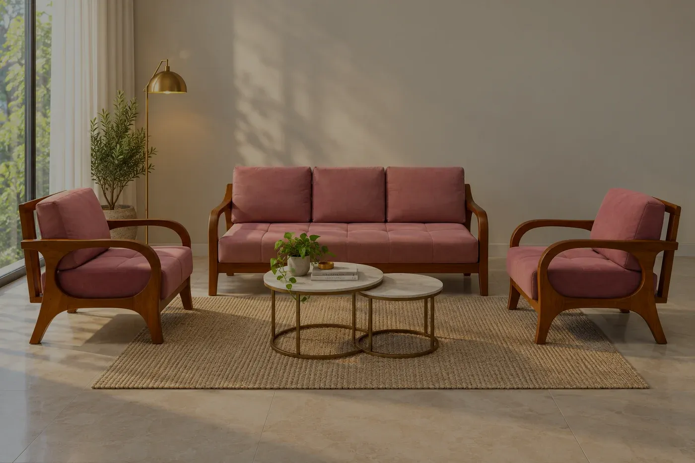 A dusty-rose sofa and two armchairs with curved wooden arms on a woven rug, against plain plaster walls.