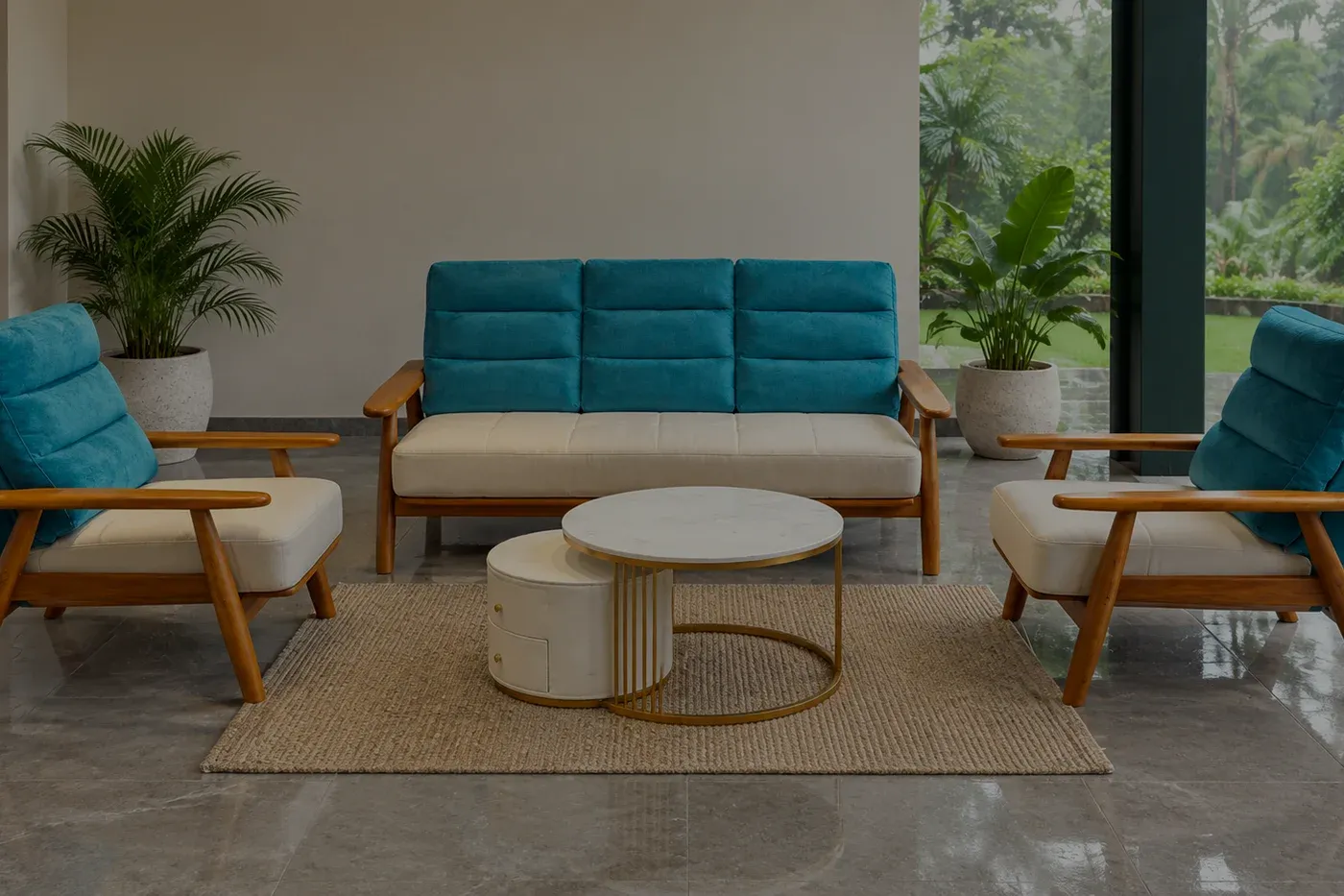 A teal and cream sofa set with a wooden frame on a polished stone floor, open to a garden along one side.