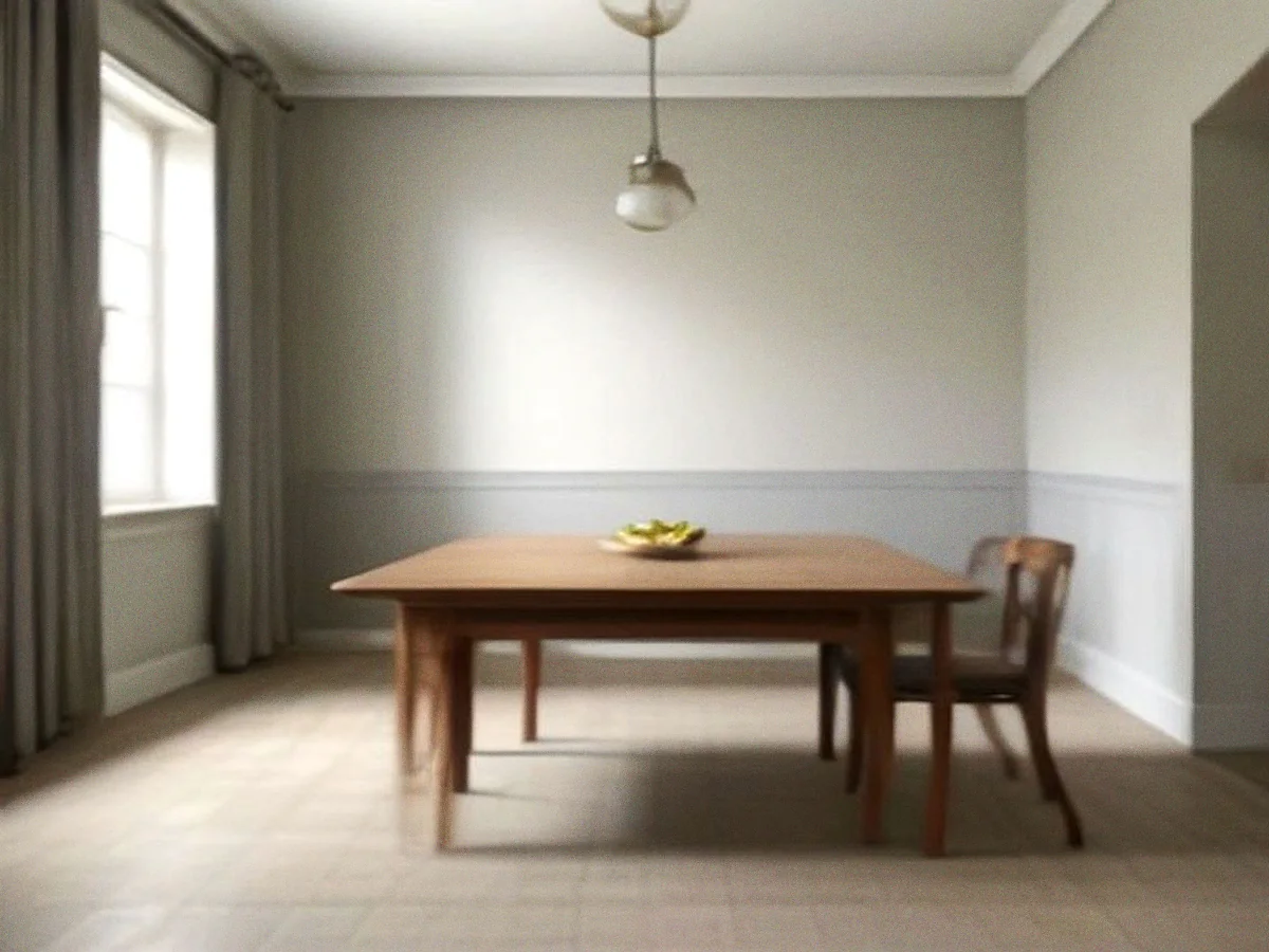 A long teak dining table with square tapered legs standing in a bare room, one chair drawn up to the far end.